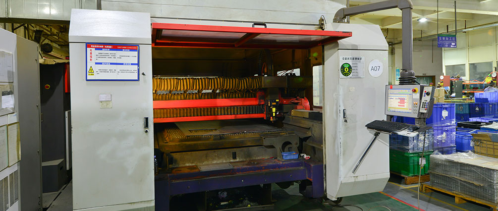 Large sheet-metal machine or press in production setting.