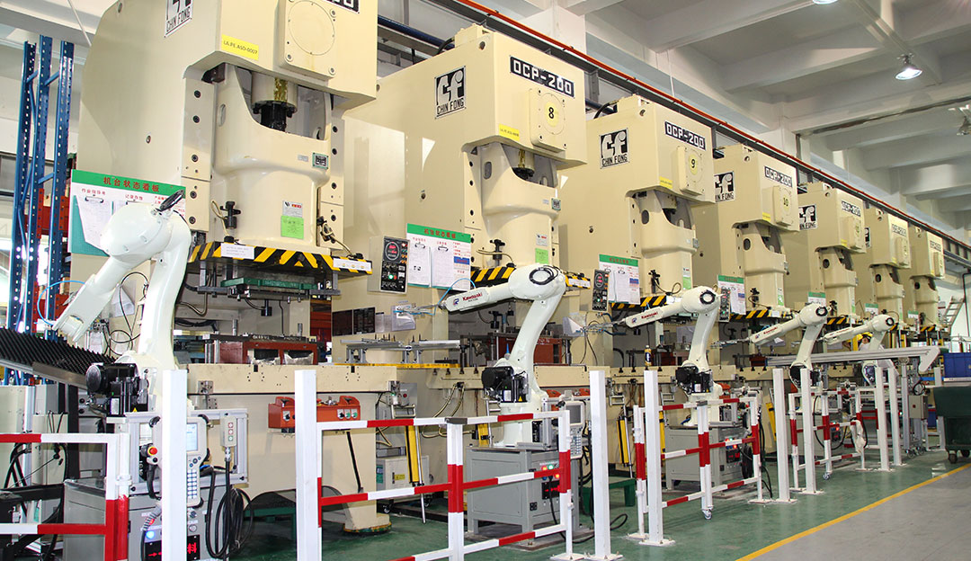 Press line or automated production line in a clean factory aisle.
