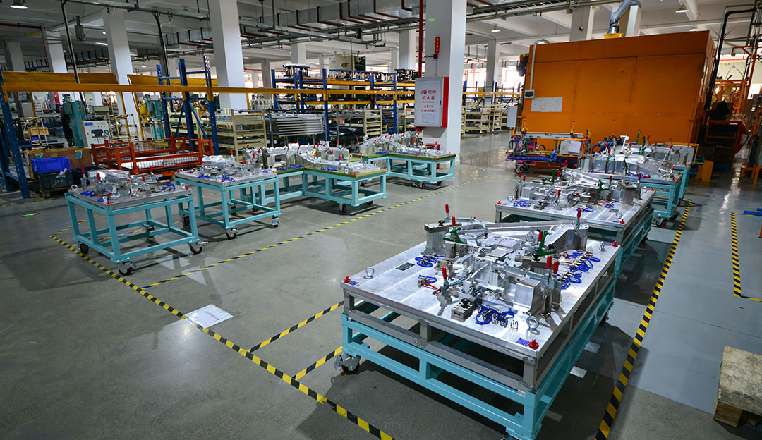 Production floor with large stamping tooling and equipment.