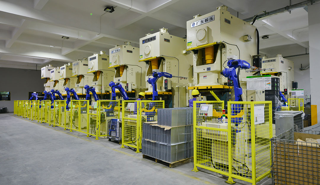 Row of presses or stamping equipment in production area.