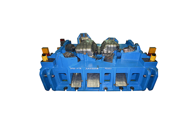 Blue tooling die assembly with visible fixture details.