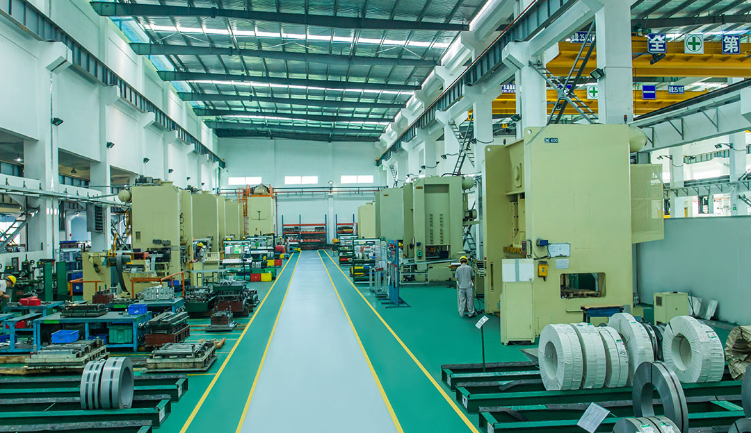 Clean production aisle with green industrial equipment and material flow.