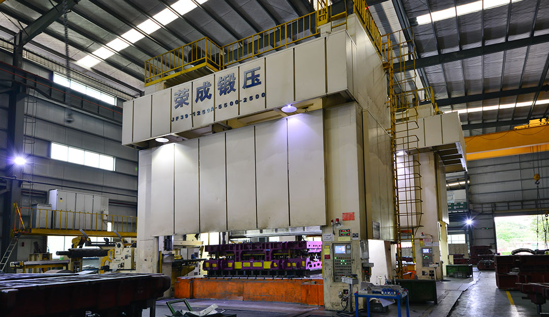 Large industrial press or forming equipment in a production hall.