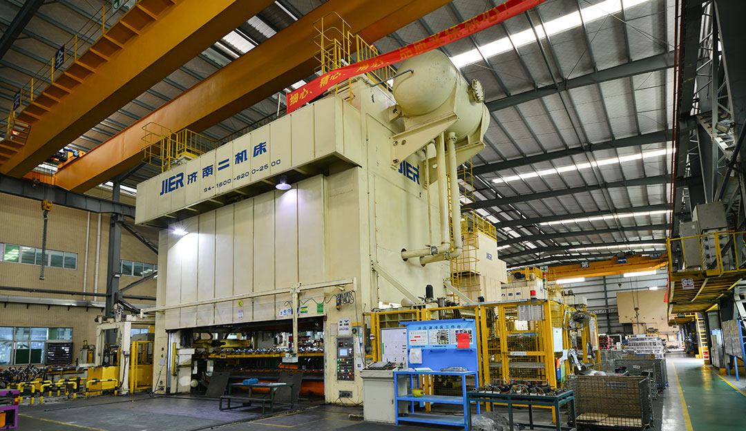 Large press or forming equipment inside a production workshop.
